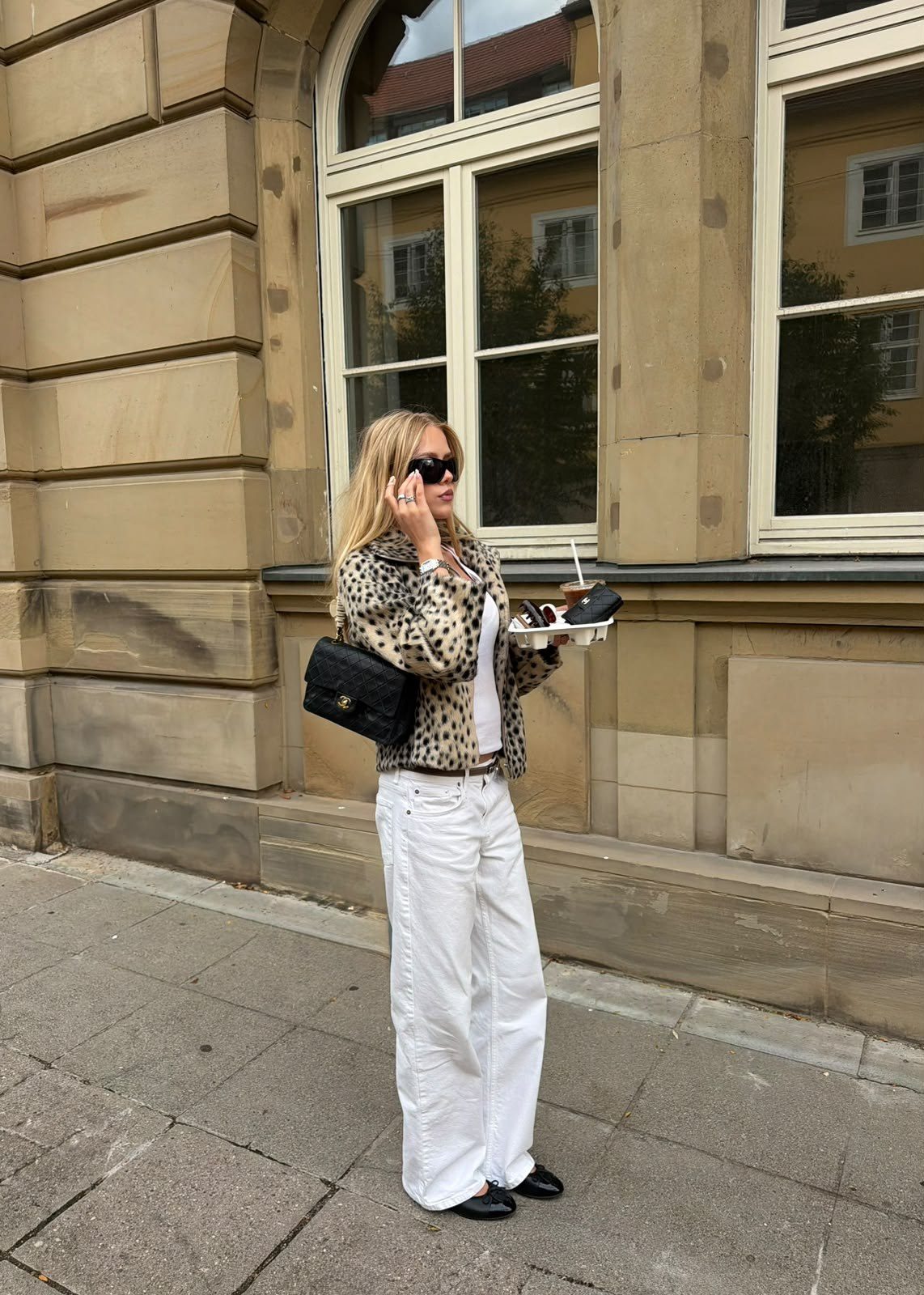Milla in the city in a leopard jacket